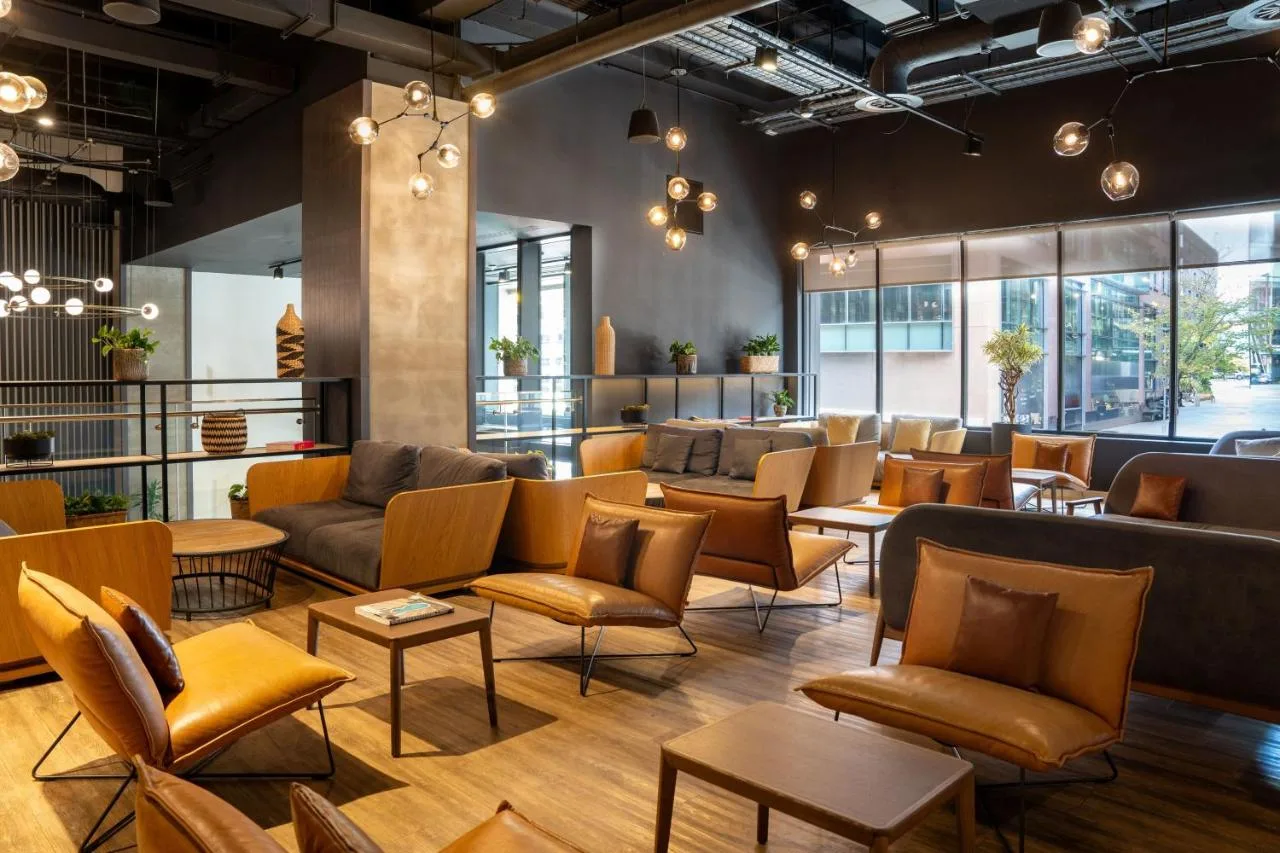 Guest waiting area with couches and tables at INNSiDE by Meliá Liverpool